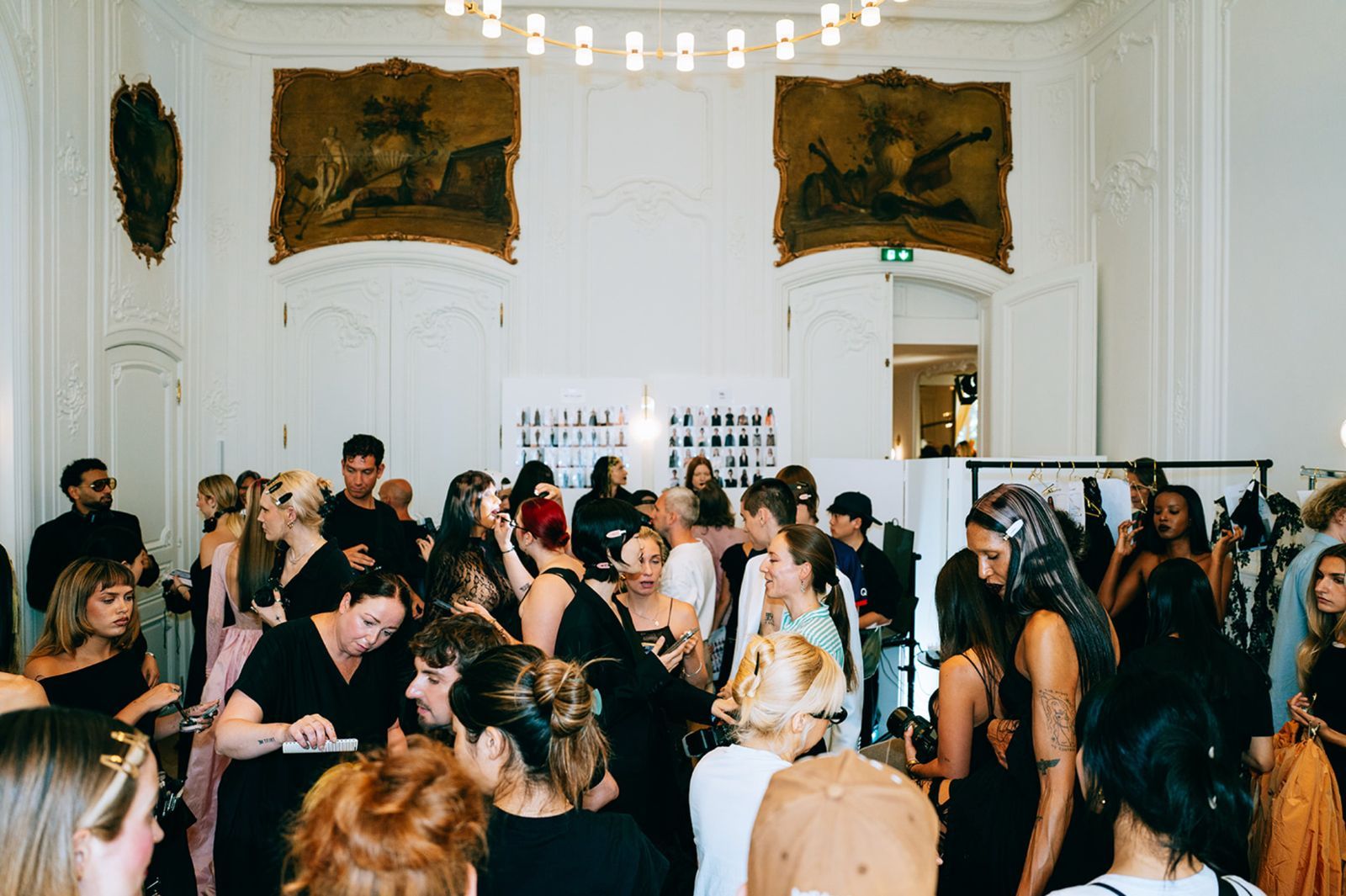 Hairstylist working backstage at a fashion show during the Kuro Academy Backstage Masterclass